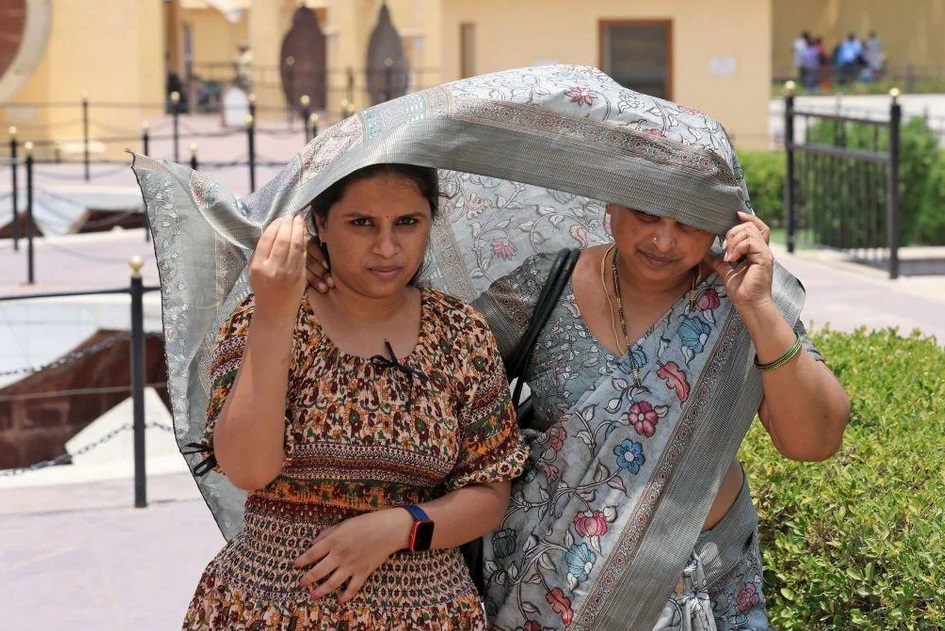 Phụ nữ dùng khăn để che chắn khỏi nắng nóng tại bang Rajasthan. Ảnh: Getty Images